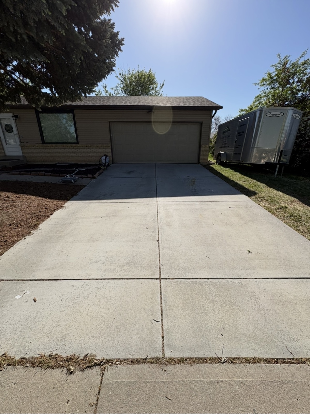 Driveway before Front Range pressure washing, showing dirt and staining