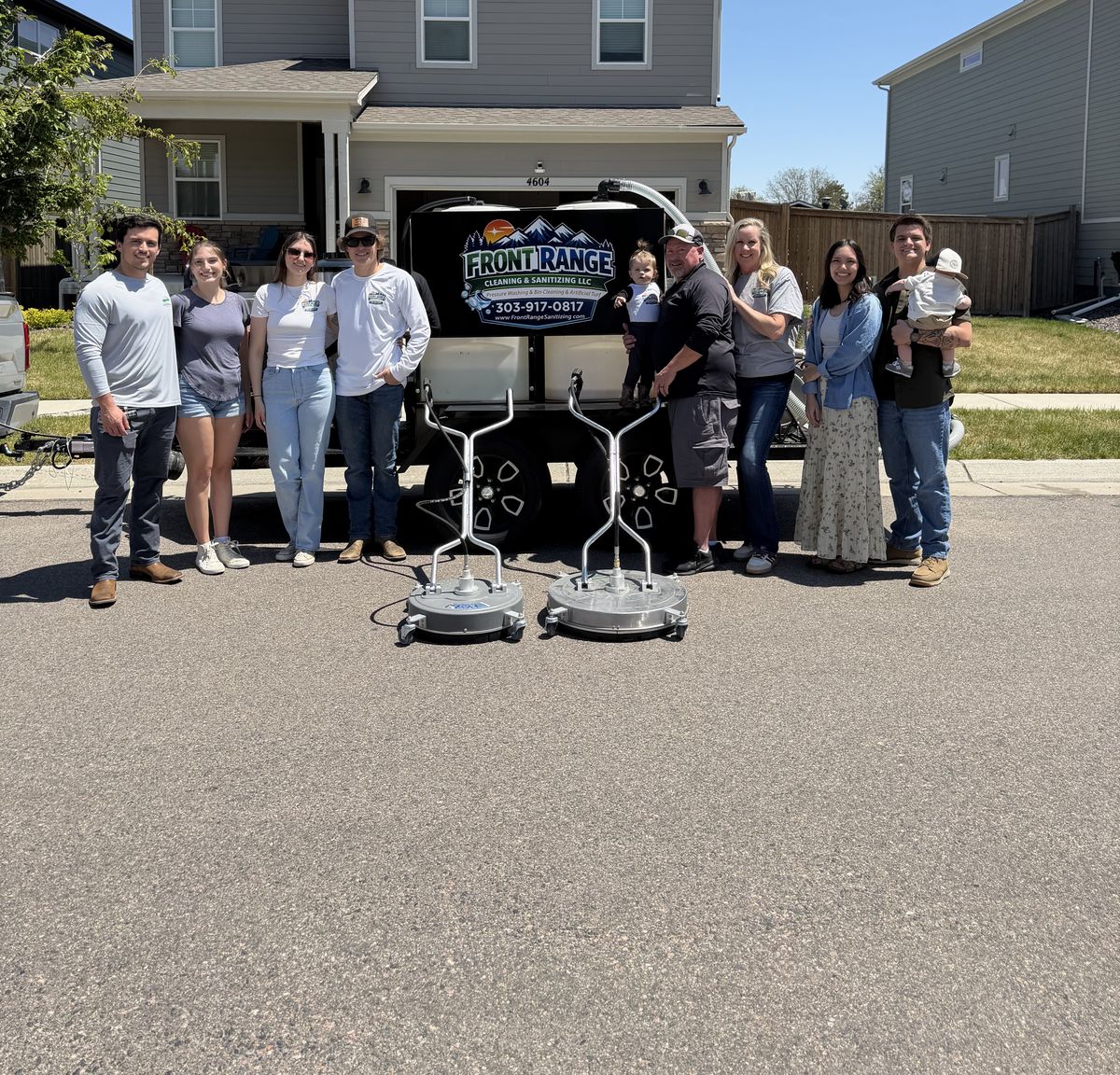 The Freddolino family standing with the Front Range Cleaning and Sanitizing trailer